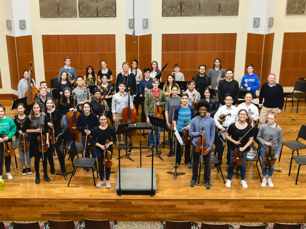 Conductor Dinis Sousa and Orchestre Révolutionnaire et Romantique musicians after working with an ensemble of Merit School for Music and CMPI students.