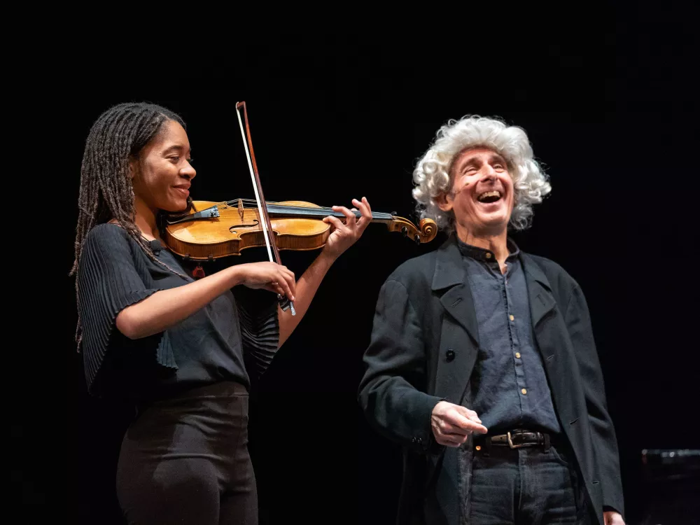 Young CMS musician playing the strings next to Bruce Adolphe as "Leaping Leopold"