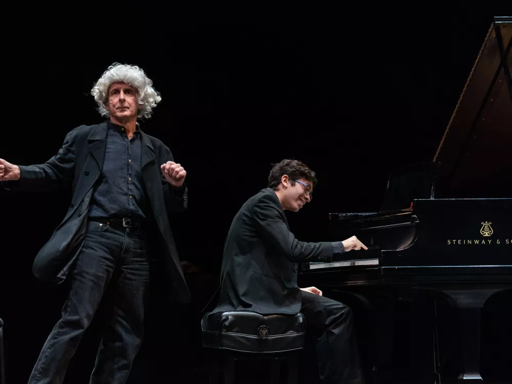 Bruce Adolphe as "Leaping Leopold" performing next to a young CMS musician playing the piano.