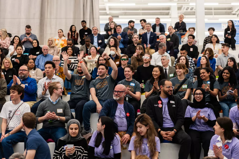 A group of people sitting and cheering.