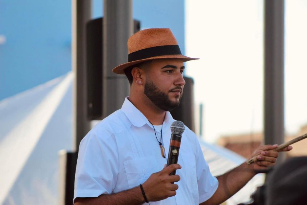 Image of Jose Rivera holding a microphone.