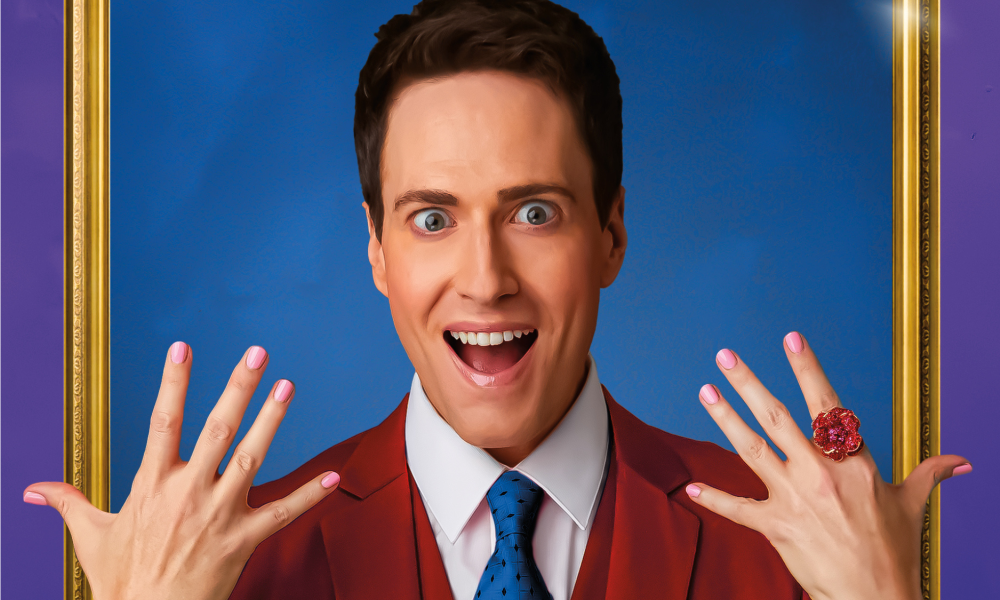 A photo of Randy Rainbow holding up his hands.