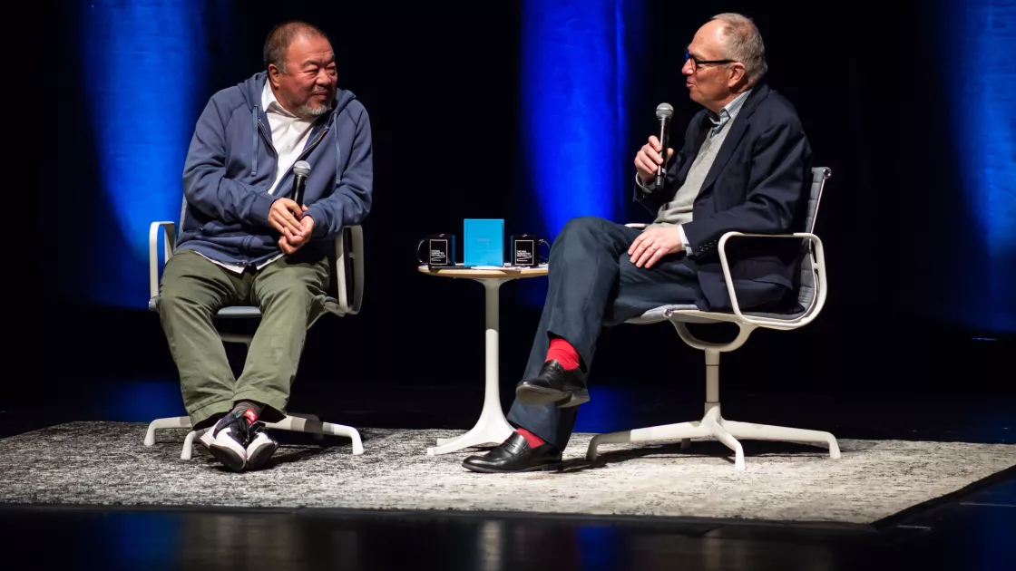 Image of Ai Weiwei and Ian Baruma in conversation on the Harris Theater stage. 