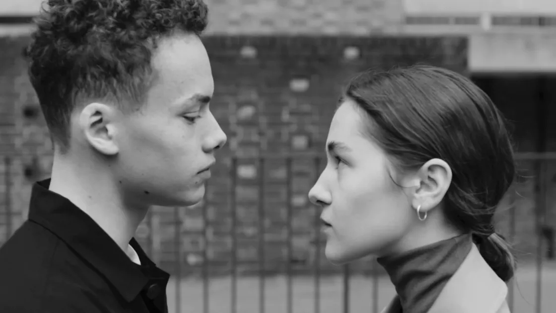 Two dancers looking at each other before a kiss