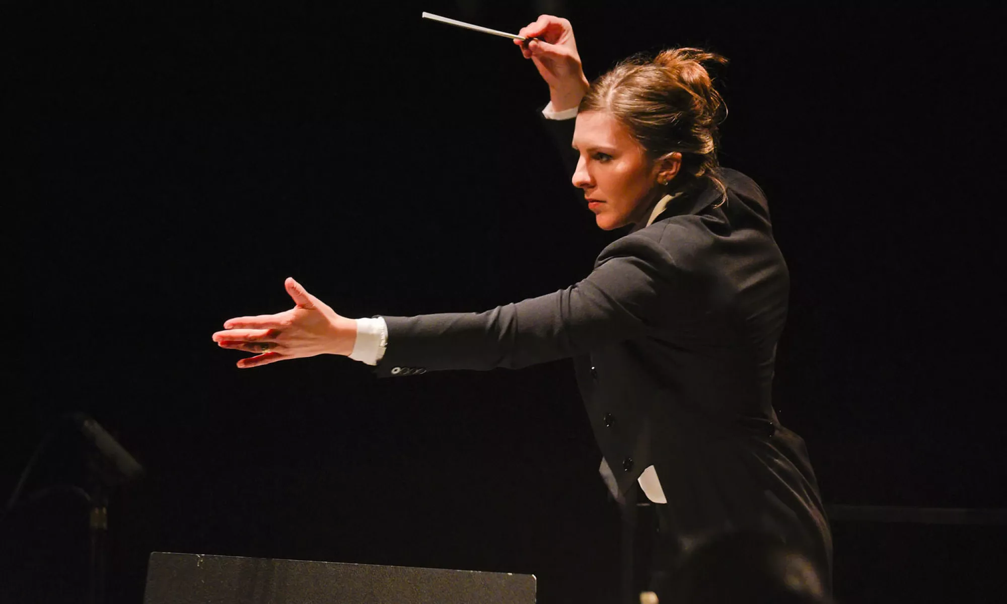 Lidiya Yankovskaya conducting with her arms stretched in front of her