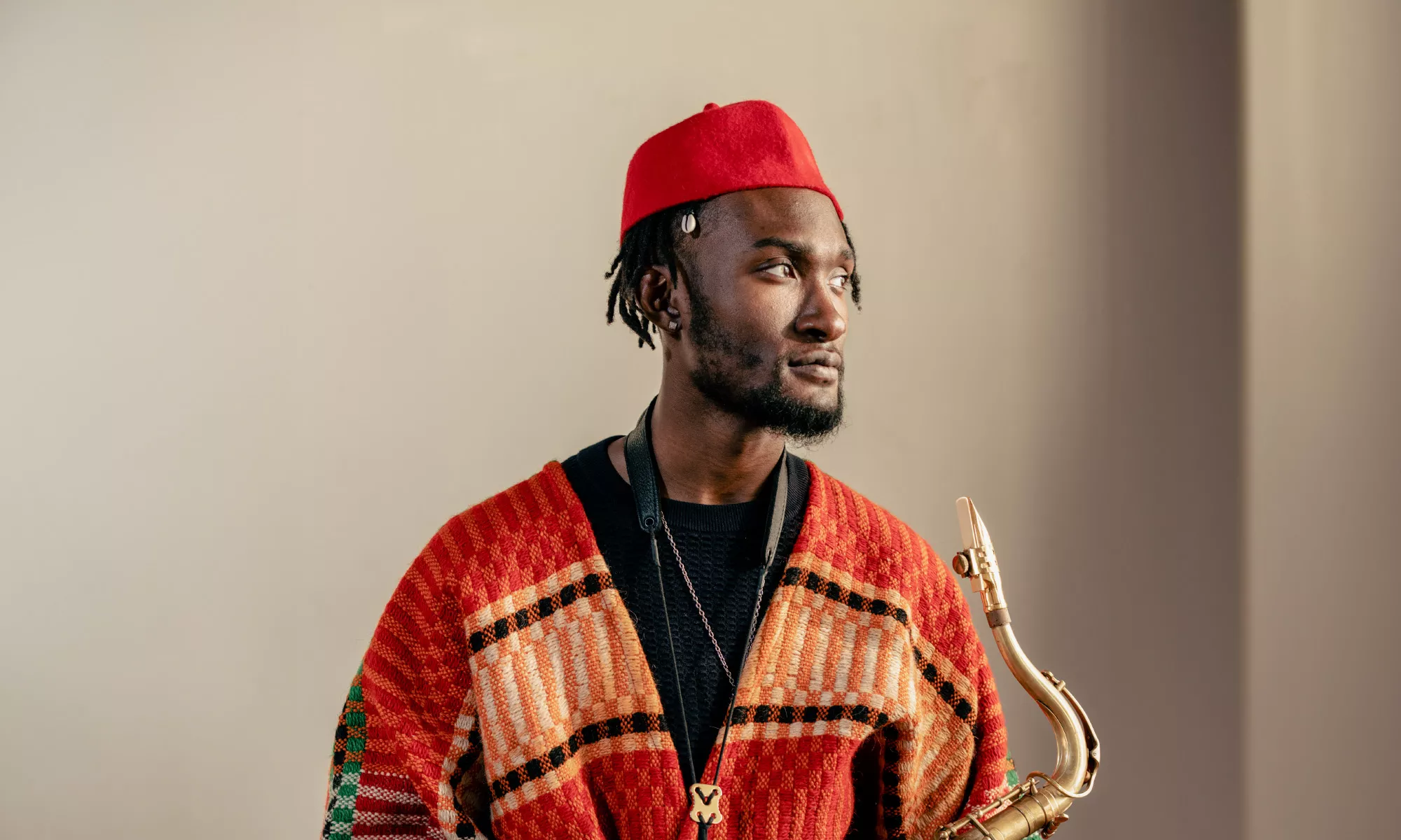 Image of Isaiah Collier holding his saxophone. 