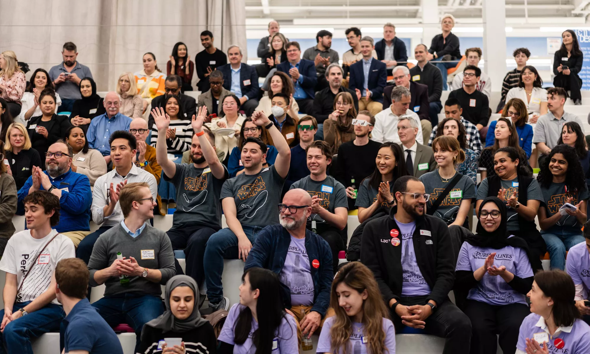 A group of people sitting and cheering.