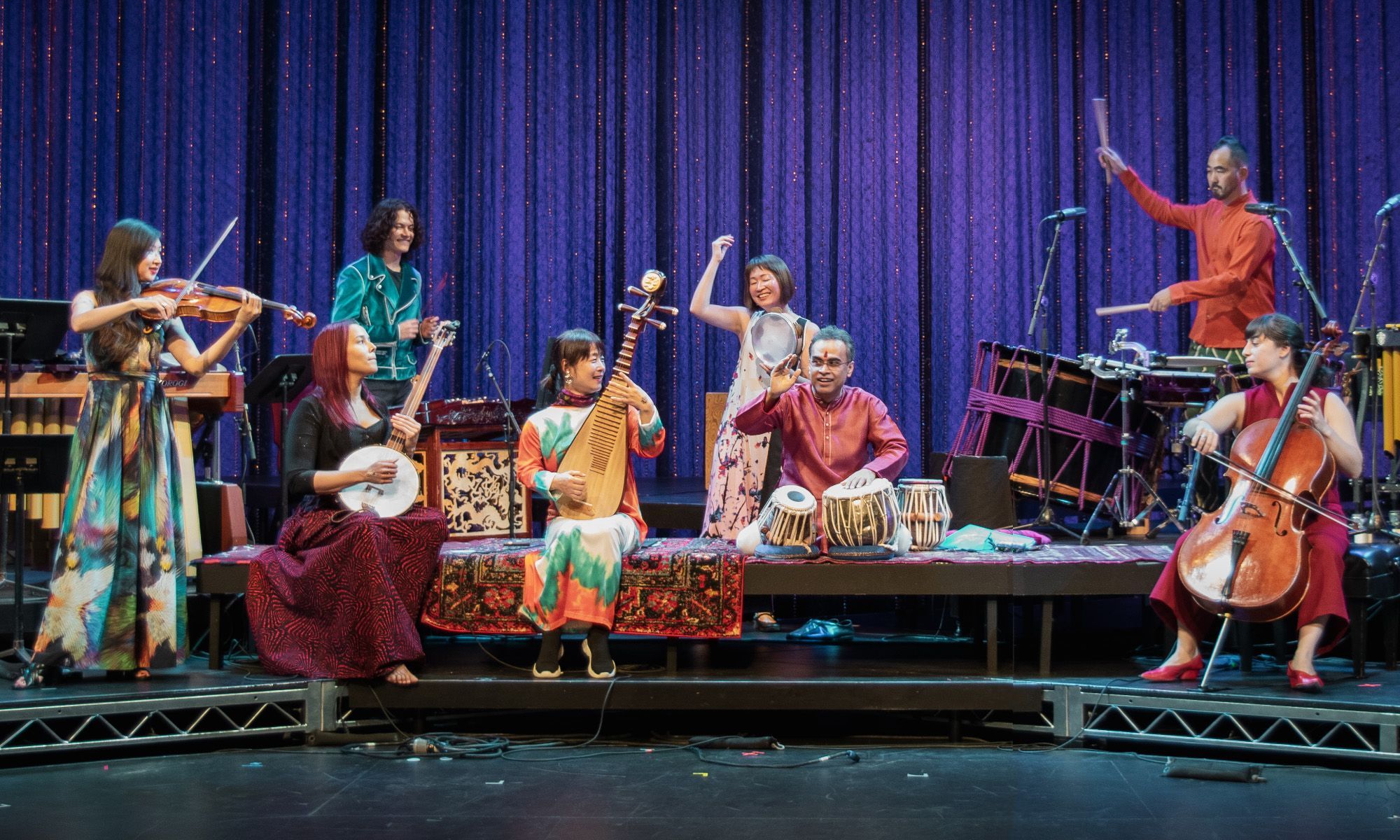 An ensemble of performers playing an assortment of instruments.