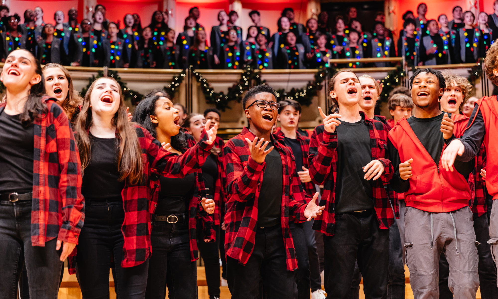 Voice of Chicago emoting while singing wearing black and red checkered flannel shirts. 