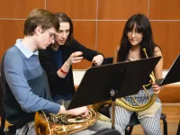 Conductor Dinis Sousa and Orchestre Révolutionnaire et Romantique musicians work with an ensemble of Merit School for Music and CMPI students.