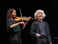 Young CMS musician playing the strings next to Bruce Adolphe as "Leaping Leopold"