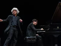 Bruce Adolphe as "Leaping Leopold" performing next to a young CMS musician playing the piano.