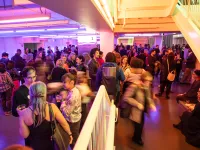 A crowd in the Lobby of the Harris Theater.