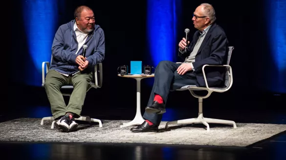 Image of Ai Weiwei and Ian Baruma in conversation on the Harris Theater stage. 