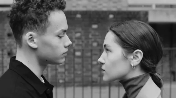 Two dancers looking at each other before a kiss