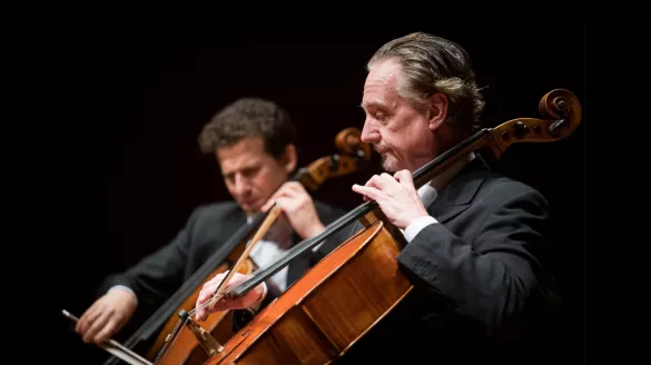 David Finckel playing on stage with another musician. 