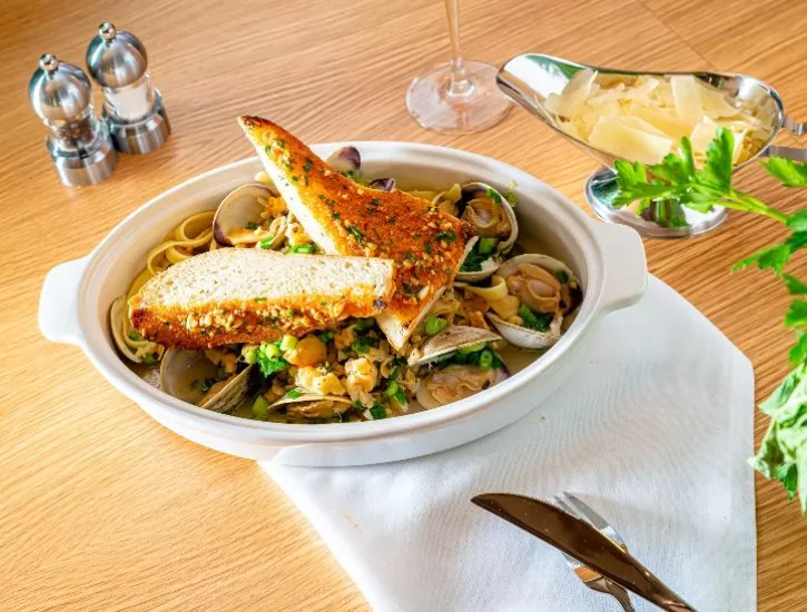 Toasted bread with oysters and parmesan cheese on the side with salt and pepper for display